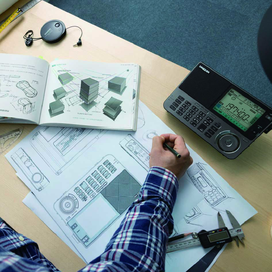 a man is drawing the blueprint of SANGEAN ATS-909X2